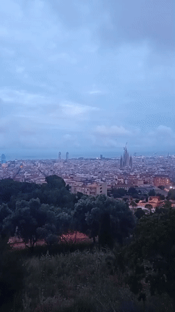 Barcelona cityscape filmed showing Sagrada Familia construction under overcast skies