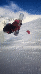 Snowboarder in red jacket descends slope near Villeurbanne