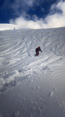 Snowboarder in red jacket descends slope near Villeurbanne