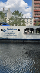 Tourist boat carries sightseers through Paris canal