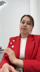 Woman in starred red blazer observed in office setting