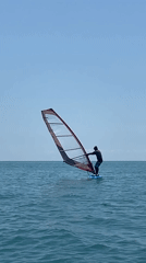 Woman enjoys morning water sports session near bridge waterfront