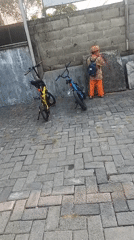Morning street life on the brick sidewalks of Pepe, Indonesia