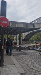 Parisians observe canal boats, watch TV during afternoon moments