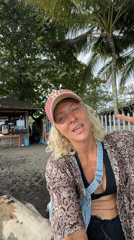Women with surfboard spotted near black-sand beach morning scene