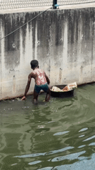 Searching through debris in a murky Jakande waterway