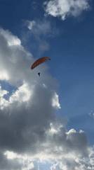 Paraglider spotted soaring over Bat Yam in clear afternoon skies