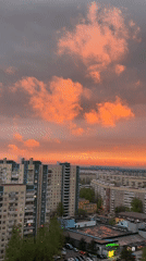 Dramatic sunset illuminates Saint Petersburg skyline with orange clouds