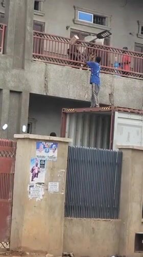 Man throws bricks from shipping container in Nigeria