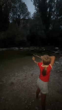 Slingshot practice on a calm riverbank in Saint-Claude