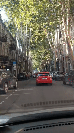 Dashcam views of Tbilisi traffic with a red double-decker bus