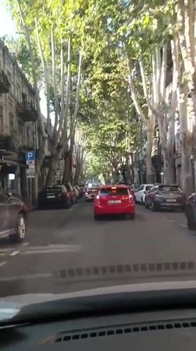 Dashcam views of Tbilisi traffic with a red double-decker bus