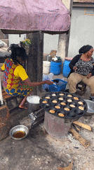 Street food vendors cook traditional Nigerian fare in Jos