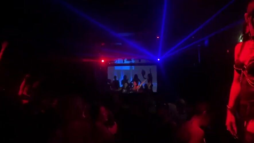 Late-night laser show and stage performance at Milan club