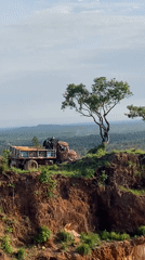 Loaded truck parked precariously on embankment edge in Nigeria