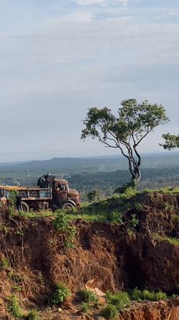 Loaded truck parked precariously on embankment edge in Nigeria