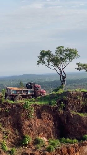 Loaded truck parked precariously on embankment edge in Nigeria