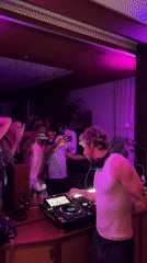 DJ runs a pink-lit set for a crowd in London