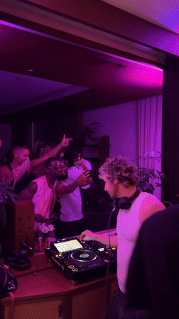 DJ runs a pink-lit set for a crowd in London