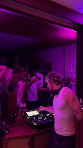 DJ runs a pink-lit set for a crowd in London