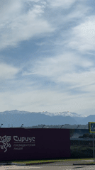 Traveler films mountain scenery from vehicle near Sirius, Russia