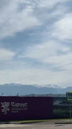 Traveler films mountain scenery from vehicle near Sirius, Russia