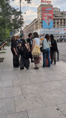 Midday street life near a Bucharest hotel, July 2026