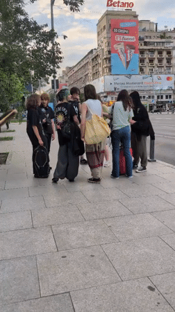 Midday street life near a Bucharest hotel, July 2026