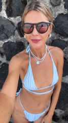 Tourist takes selfie against stone wall in North Kuta