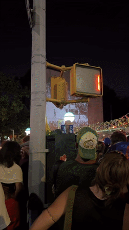 Brooklyn crowd watches basketball game projected on building wall