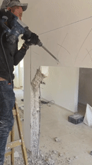Worker demolishes wall with jackhammer in Bat Yam