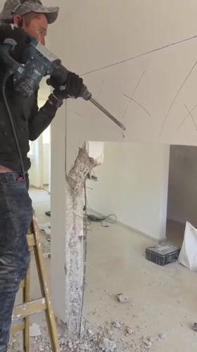 Worker demolishes wall with jackhammer in Bat Yam