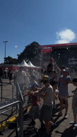 Summer carnival underway in Kiel with rides, crowds, and live stage