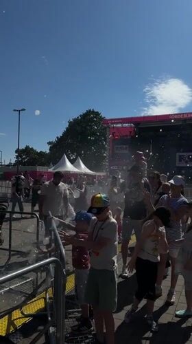 Summer carnival underway in Kiel with rides, crowds, and live stage
