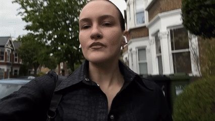Person in black walks London residential street