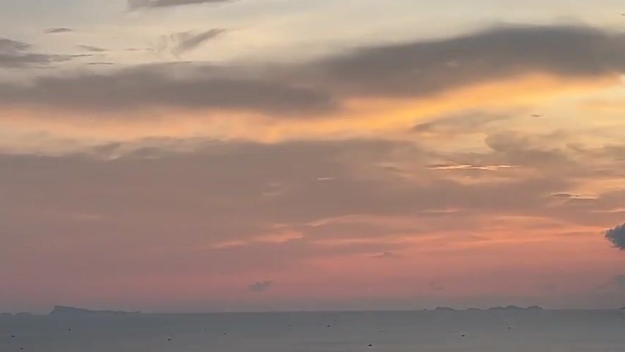 Sunset panorama documented from Thai coastal hillside viewpoint