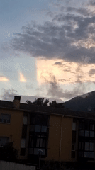 Sunset light breaks through clouds over Sant Joan Les Fonts