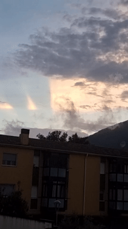Sunset light breaks through clouds over Sant Joan Les Fonts