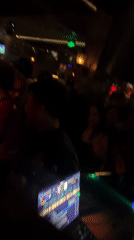 Nightclub Scene Captured in Liangjiang with DJ, Dancing, Sports TV