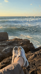 Person takes meditation break on Tel Aviv shore