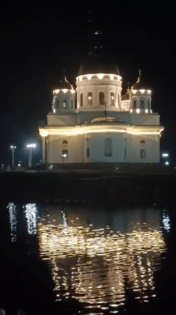 Evening photography captures illuminated Kokshetau landmarks and waterfront reflections