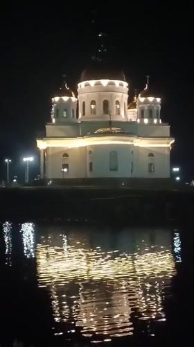 Evening photography captures illuminated Kokshetau landmarks and waterfront reflections