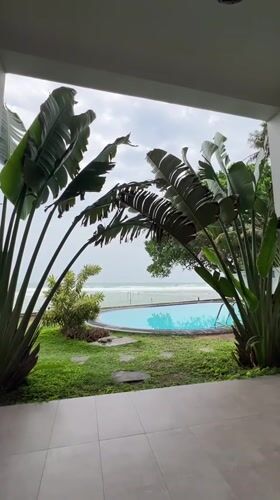 Guitarist plays indoors as waves crash outside Sri Lankan coast