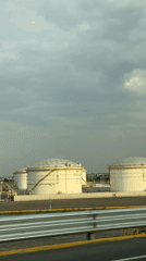 Industrial storage tanks filmed from vehicle in Huejotzingo, Mexico