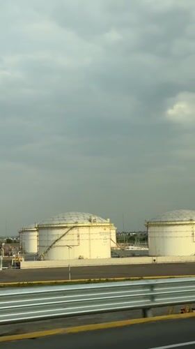 Industrial storage tanks filmed from vehicle in Huejotzingo, Mexico