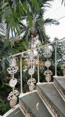 Visitor documents ornate staircase, tropical plants in London conservatory