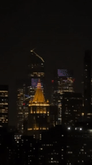 Nighttime NYC skyline captured with prominent domed building