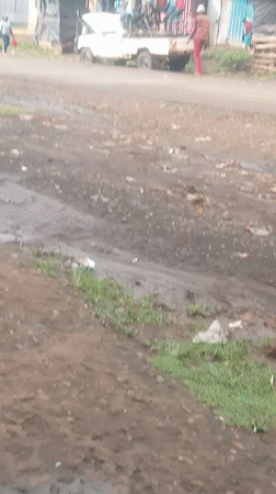 Toyota truck transports passengers on muddy rural road