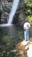 Morning hiker photographed at Bhagsu waterfall in Himalayan foothills