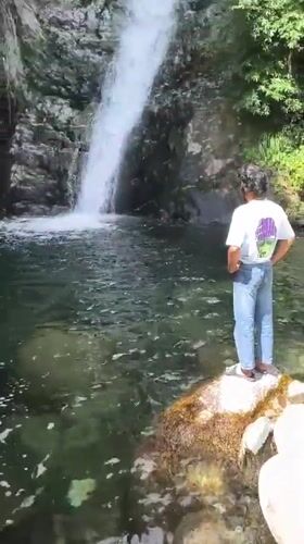 Morning hiker photographed at Bhagsu waterfall in Himalayan foothills
